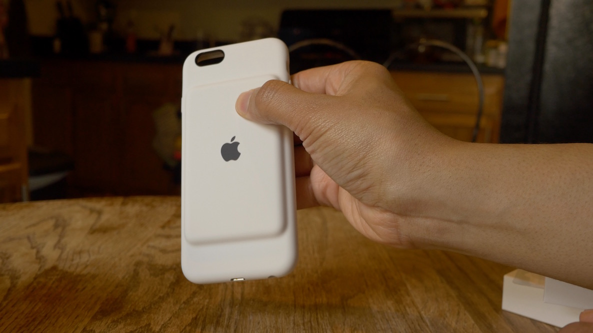 A photo showing a hand holding Apple's Smart Battery Case for iPhone
